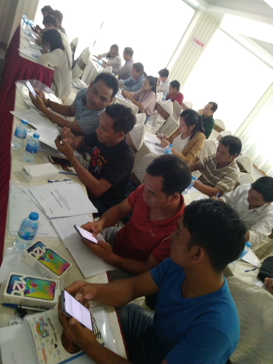 Members were practicing with data collection software about malaria on smartphone